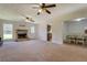 Spacious living room featuring a fireplace, carpet flooring, and open access to dining room at 5687 Highway 212, Covington, GA 30016