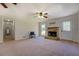 Inviting living room featuring a stone fireplace, neutral walls and fan at 5687 Highway 212, Covington, GA 30016