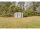 Metal storage shed in backyard surrounded by trees and grass at 5687 Highway 212, Covington, GA 30016