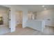 Bright hallway with light wood floors leads to a laundry room and bedrooms at 113 Priestwood Ln, Acworth, GA 30102