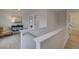 Hallway featuring neutral walls, modern decor, and light wood floors leading to other rooms at 113 Priestwood Ln, Acworth, GA 30102
