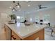 Open kitchen concept with stainless steel appliances, pendant lighting, and a large island, seamlessly flowing into the living space at 113 Priestwood Ln, Acworth, GA 30102