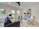 Inviting living room with a plush sofa, modern decor, and lots of natural light at 113 Priestwood Ln, Acworth, GA 30102