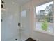 Modern glass shower with black fixtures and outside view through a window at 113 Priestwood Ln, Acworth, GA 30102