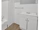 All-white bathroom showcasing the neutral tile and vanity storage at 2739 Council St, Lithonia, GA 30058
