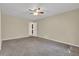Large bedroom with neutral walls, plush carpeting, ceiling fan, and multiple closets at 2739 Council St, Lithonia, GA 30058