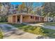 A charming brick home with red shutters and a long driveway at 2739 Council St, Lithonia, GA 30058