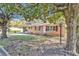 Charming brick ranch-style home with red shutters, mature trees, and landscaped front yard at 2739 Council St, Lithonia, GA 30058