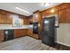 Well-equipped kitchen featuring dark cabinets, stainless appliances, and modern flooring at 2739 Council St, Lithonia, GA 30058
