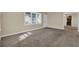 Cozy living room featuring plush carpet, neutral paint, and natural light at 2739 Council St, Lithonia, GA 30058