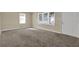 Bright living room with neutral paint and carpet, featuring two windows allowing for great natural light at 2739 Council St, Lithonia, GA 30058