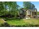 Beautiful backyard with a stone fireplace, deck, and patio create a serene outdoor living space at 404 Queensbury Pl, Acworth, GA 30102