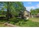 Spacious backyard features a stone fireplace, deck and patio, perfect for outdoor entertaining and relaxation at 404 Queensbury Pl, Acworth, GA 30102
