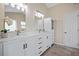 This updated bathroom features a double vanity with a stone countertop and soft lighting at 404 Queensbury Pl, Acworth, GA 30102