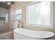 Bright bathroom features a modern soaking tub and glass enclosed shower at 404 Queensbury Pl, Acworth, GA 30102