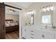 This updated bathroom features a double vanity with a stone countertop and barn door entry at 404 Queensbury Pl, Acworth, GA 30102