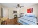 Bedroom with hardwood floors, a ceiling fan, and a large television at 404 Queensbury Pl, Acworth, GA 30102