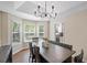 Bright dining room featuring hardwood floors, a large table, and natural light from the windows at 404 Queensbury Pl, Acworth, GA 30102