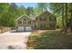Charming home with a two-car garage and well-maintained lawn offers great curb appeal in a suburban neighborhood at 404 Queensbury Pl, Acworth, GA 30102