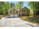 Charming home featuring a two-car garage, beautiful landscaping, and a well-maintained front yard at 404 Queensbury Pl, Acworth, GA 30102