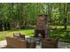 Outdoor stone fireplace surrounded by comfortable seating, creating a cozy ambiance at 404 Queensbury Pl, Acworth, GA 30102