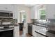 Modern kitchen featuring stainless steel appliances, granite countertops, and ample cabinet space at 404 Queensbury Pl, Acworth, GA 30102