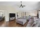 Open living room with vaulted ceiling, comfortable gray sectional sofa, and hardwood floors at 404 Queensbury Pl, Acworth, GA 30102