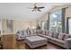 Spacious living room with vaulted ceiling, large windows, and comfortable gray sectional sofa at 404 Queensbury Pl, Acworth, GA 30102