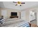 A cozy main bedroom features a trey ceiling, ceiling fan and an ensuite bathroom at 404 Queensbury Pl, Acworth, GA 30102