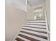 Elegant staircase featuring wood treads and white risers, leading to the upper level of the home at 404 Queensbury Pl, Acworth, GA 30102