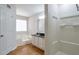 Bathroom featuring a tub, stand up shower, and a vanity with black countertop, for a relaxing experience at 5551 Panola Pl, Lithonia, GA 30058