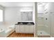 Bathroom featuring double sinks, a stand up shower, and a tub for a relaxing, spa-like experience at 5551 Panola Pl, Lithonia, GA 30058