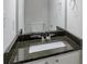 Elegant bathroom featuring granite countertops, a stylish mirror, and modern fixtures at 5551 Panola Pl, Lithonia, GA 30058
