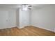 Bright bedroom featuring hardwood floors, a ceiling fan, and two closets at 5551 Panola Pl, Lithonia, GA 30058