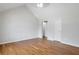 Bedroom with vaulted ceiling, wood floors, and white doors, offering a bright and airy space at 5551 Panola Pl, Lithonia, GA 30058