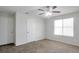 Bedroom with neutral walls, carpet, doors, and a large window providing natural light at 5551 Panola Pl, Lithonia, GA 30058