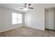 Bedroom with neutral walls, carpet, doors, and a large window providing natural light at 5551 Panola Pl, Lithonia, GA 30058