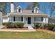 Charming home featuring black door and shutters, white siding, well-kept lawn and sidewalk access at 5551 Panola Pl, Lithonia, GA 30058