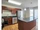 Open kitchen featuring stainless steel appliances, island with granite countertop and a window for natural light at 5551 Panola Pl, Lithonia, GA 30058
