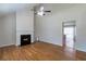 Bright living room with a fireplace, ceiling fan, hardwood floors and smooth transition into the kitchen at 5551 Panola Pl, Lithonia, GA 30058