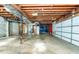 Unfinished basement with exposed utilities, garage door, and concrete floor at 2727 Whites Mill Ct, Decatur, GA 30034