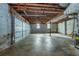Unfinished basement with exposed utilities, garage door, and concrete floor at 2727 Whites Mill Ct, Decatur, GA 30034
