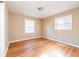 Bedroom with wood floors, two windows with mini-blinds, and neutral colored walls at 2727 Whites Mill Ct, Decatur, GA 30034
