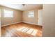 Bedroom with hardwood floors, neutral walls, two windows, and a standard door at 2727 Whites Mill Ct, Decatur, GA 30034