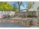 A backyard with a fire pit, surrounded by natural landscaping and a retaining wall at 273 Glenwood Se Ave # B, Atlanta, GA 30312