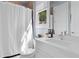 Well-lit bathroom featuring a toilet, a vanity with a white countertop, and a shower with a curtain at 273 Glenwood Se Ave # B, Atlanta, GA 30312