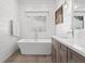 Bright and airy bathroom featuring a soaking tub, ship lap walls, and vanity with modern fixtures at 273 Glenwood Se Ave # B, Atlanta, GA 30312
