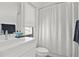 A clean bathroom featuring a stylish vanity and shower with a modern, patterned shower curtain at 273 Glenwood Se Ave # B, Atlanta, GA 30312