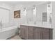 Bright bathroom with a soaking tub, stylish vanity, ship lap walls and modern lighting at 273 Glenwood Se Ave # B, Atlanta, GA 30312