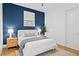 Inviting bedroom with a navy accent wall, a comfortable bed, and modern nightstands with stylish lamps at 273 Glenwood Se Ave # B, Atlanta, GA 30312